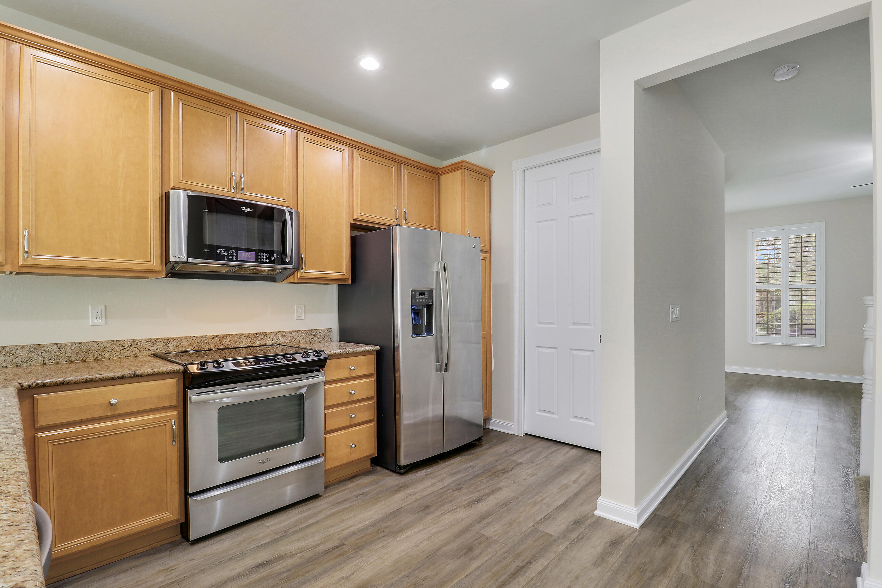 1043 Key Largo Street Jupiter, FL 33458 - Photo 16 of 46 a kitchen with stainless steel appliances granite countertop a stove a refrigerator and a microwave
