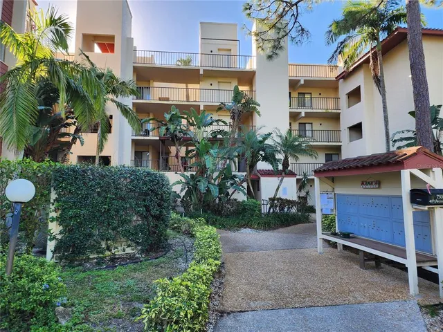 a view of building with potted plants and a bench