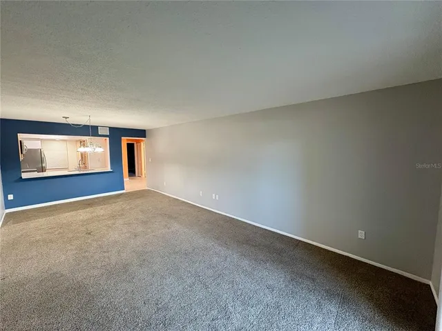 a view of an empty room with windows