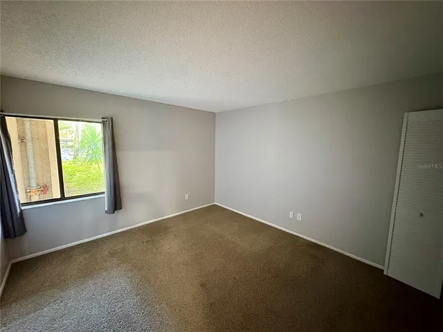 a bedroom with two beds and a chandelier
