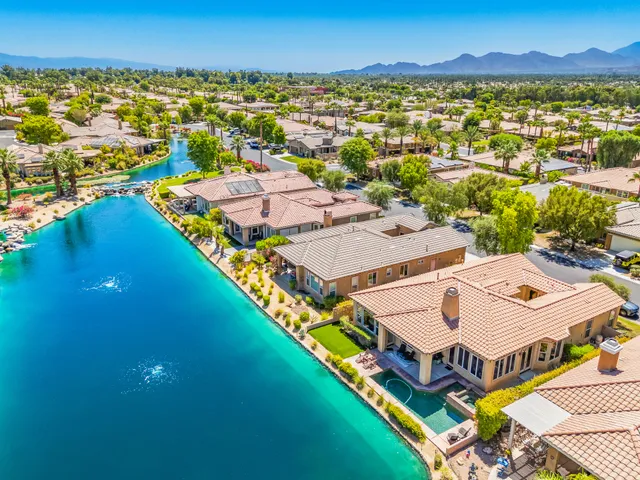 an aerial view of residential houses with outdoor space and swimming pool