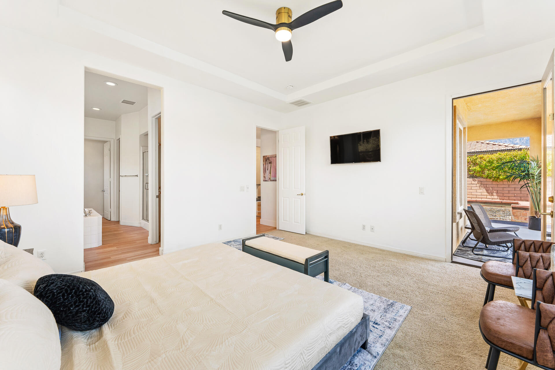 65 Shoreline Drive Rancho Mirage, CA 92270 - Photo 15 of 29 a bedroom with a bed a chair and a large window