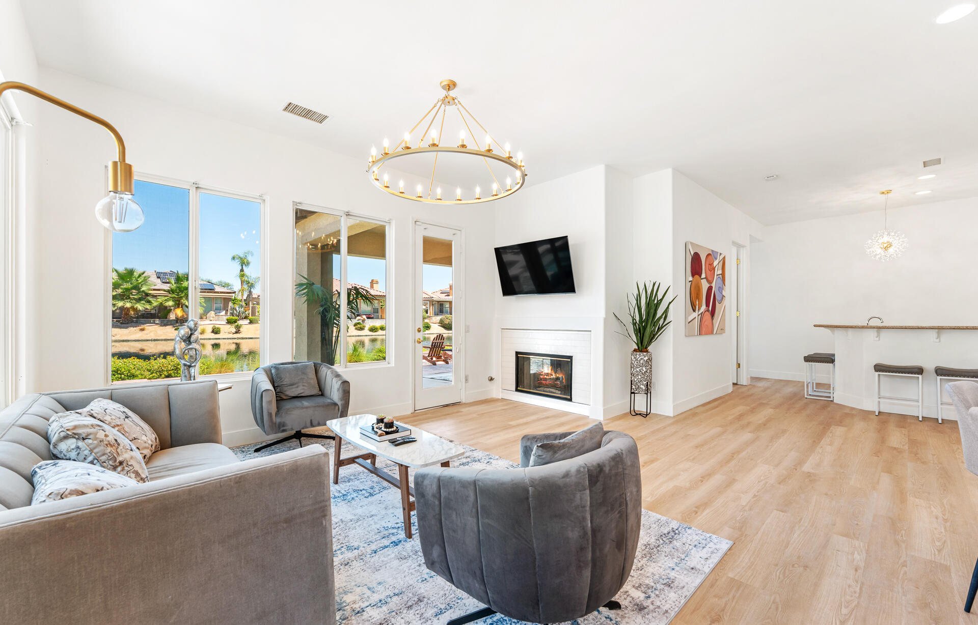 65 Shoreline Drive Rancho Mirage, CA 92270 - Photo 22 of 29 a living room with furniture a fireplace and a flat screen tv