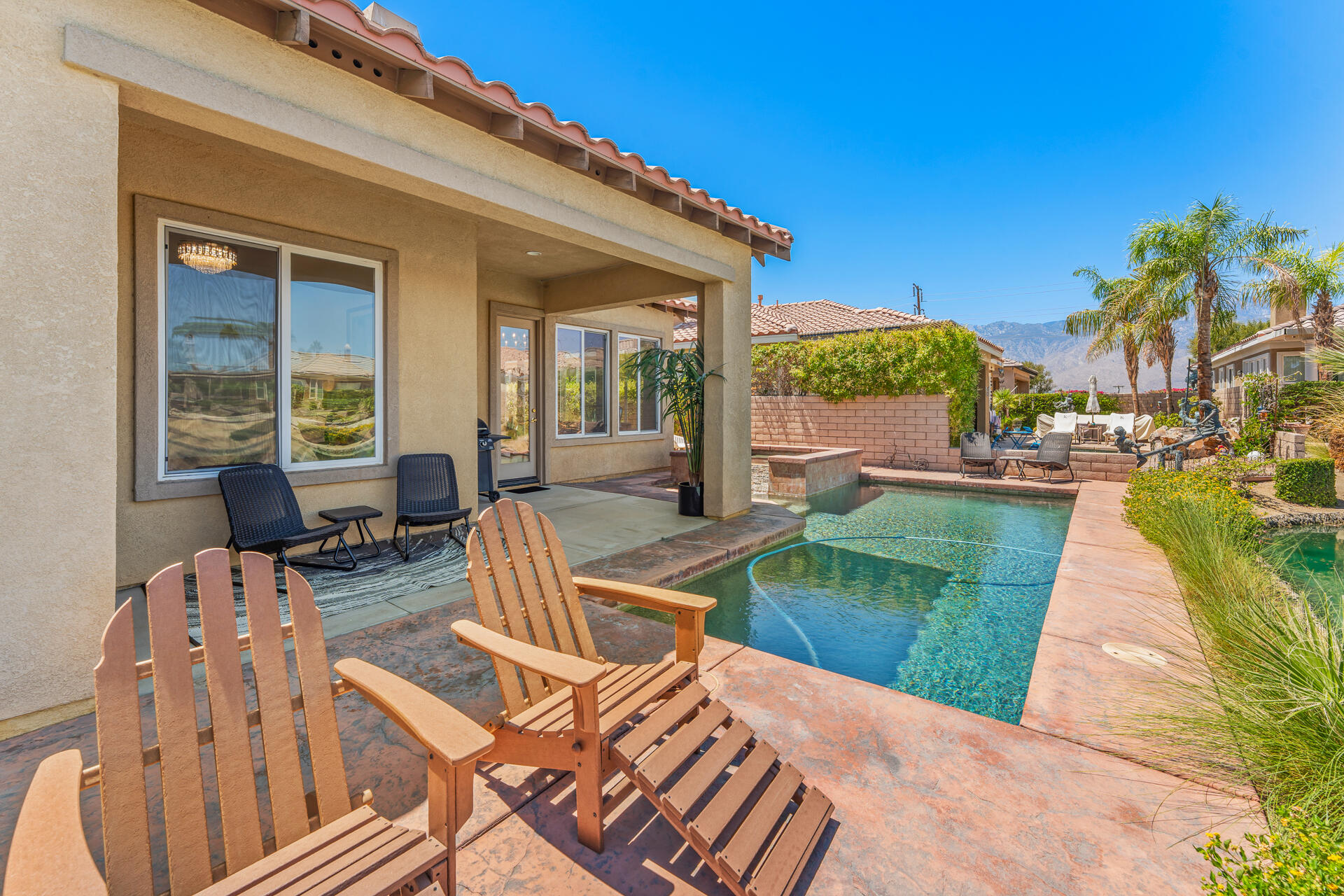 65 Shoreline Drive Rancho Mirage, CA 92270 - Photo 23 of 29 a view of a patio with couches table and chairs with wooden floor and fence