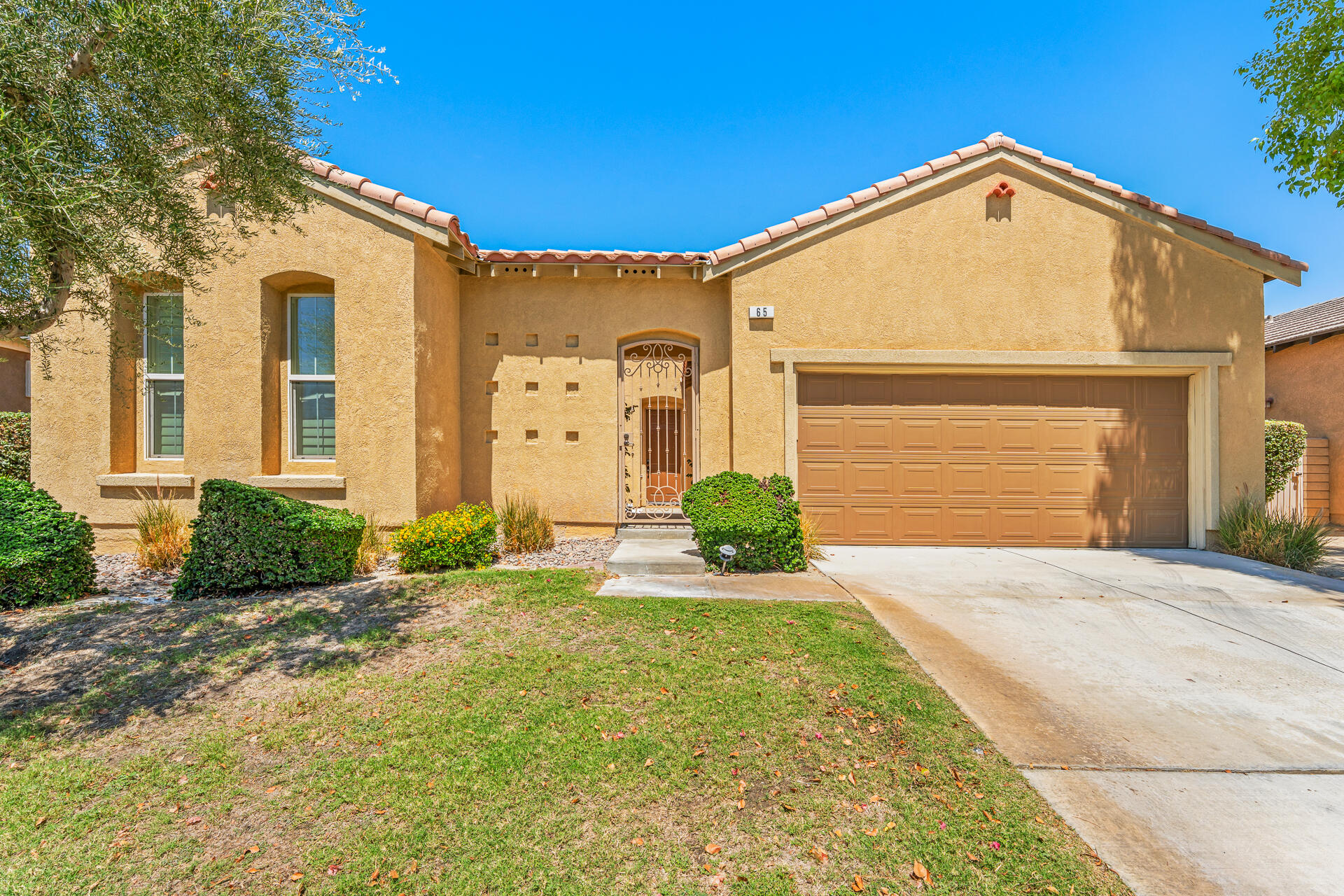 65 Shoreline Drive Rancho Mirage, CA 92270 - Photo 28 of 29 a front view of a house with a yard