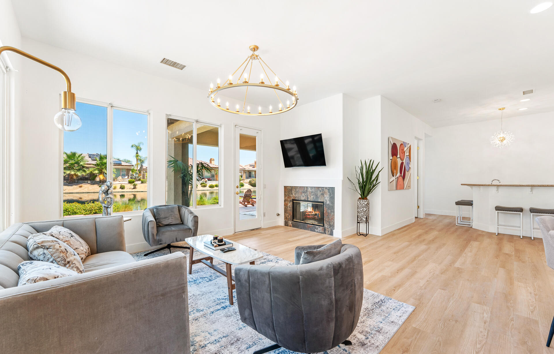 65 Shoreline Drive Rancho Mirage, CA 92270 - Photo 8 of 29 a living room with furniture a fireplace and a flat screen tv