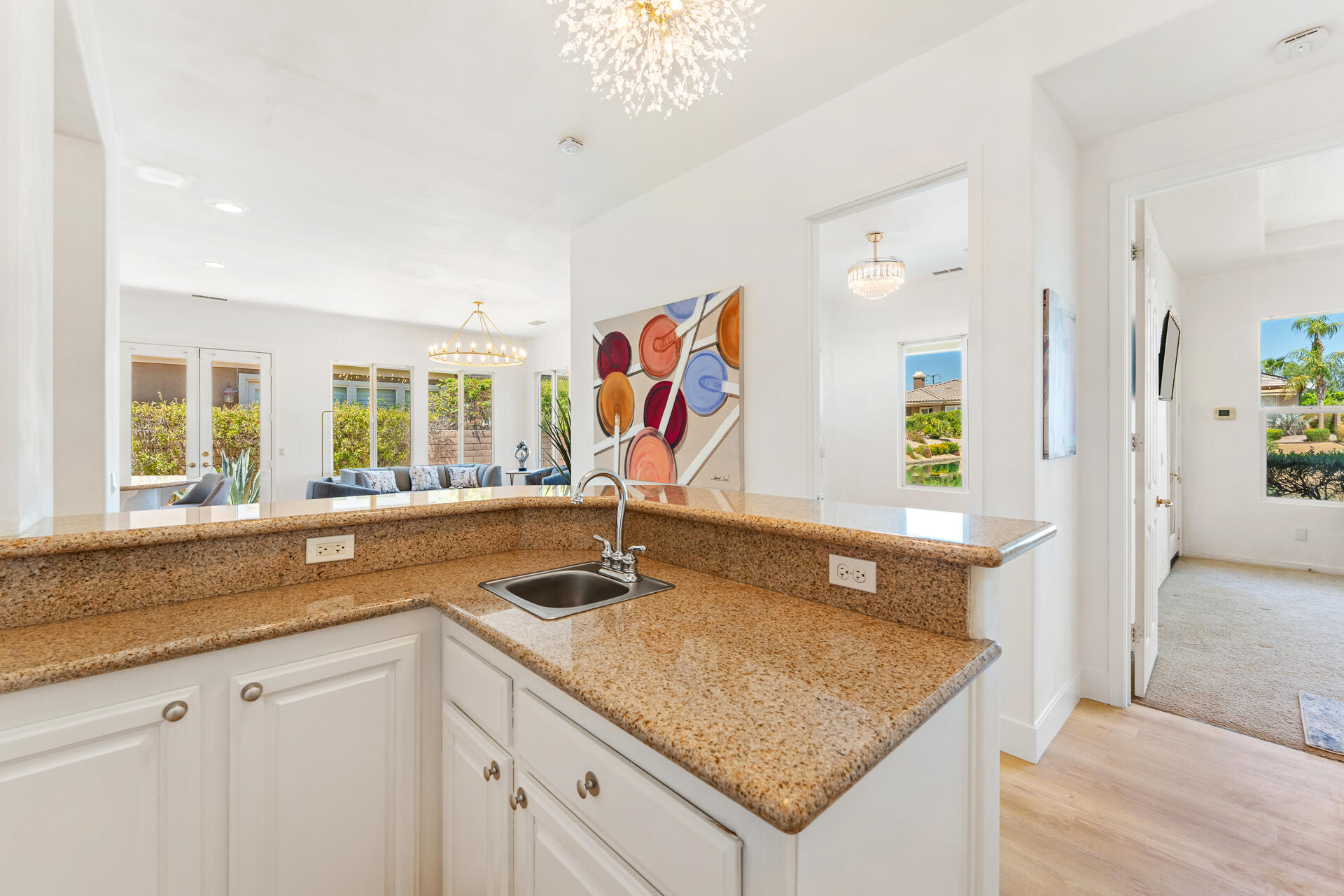 65 Shoreline Drive Rancho Mirage, CA 92270 - Photo 10 of 29 a kitchen with a sink granite counter tops and a window