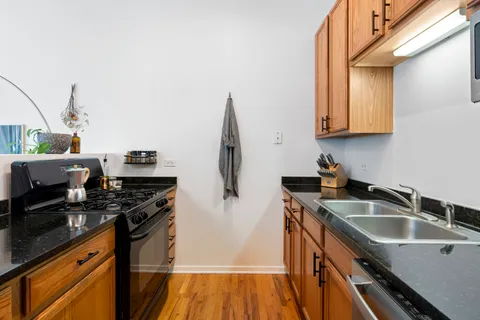 a kitchen that has a sink and a stove
