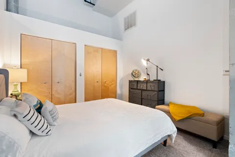 a bedroom with a bed and a couch