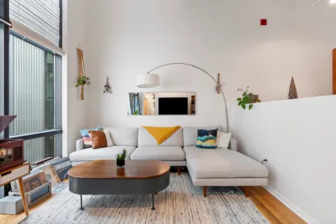 a living room with furniture and a wooden floor