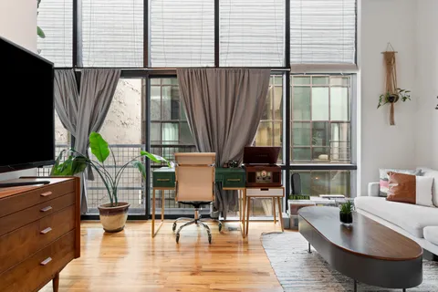 a living room with fireplace furniture and a flat screen tv