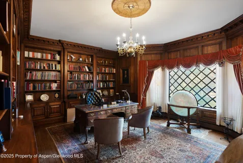 a dining room with furniture and a chandelier