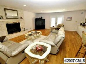 9921 Withers Road Charlotte, NC 28278 - Photo 4 of 8 a living room with furniture and a flat screen tv