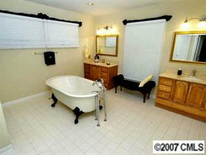 9921 Withers Road Charlotte, NC 28278 - Photo 6 of 8 a bathroom with a sink toilet and mirror