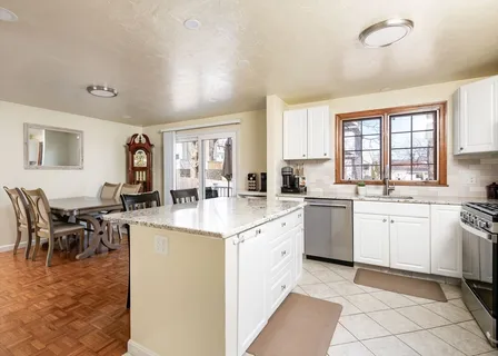 a kitchen with granite countertop cabinets a dining table and chairs