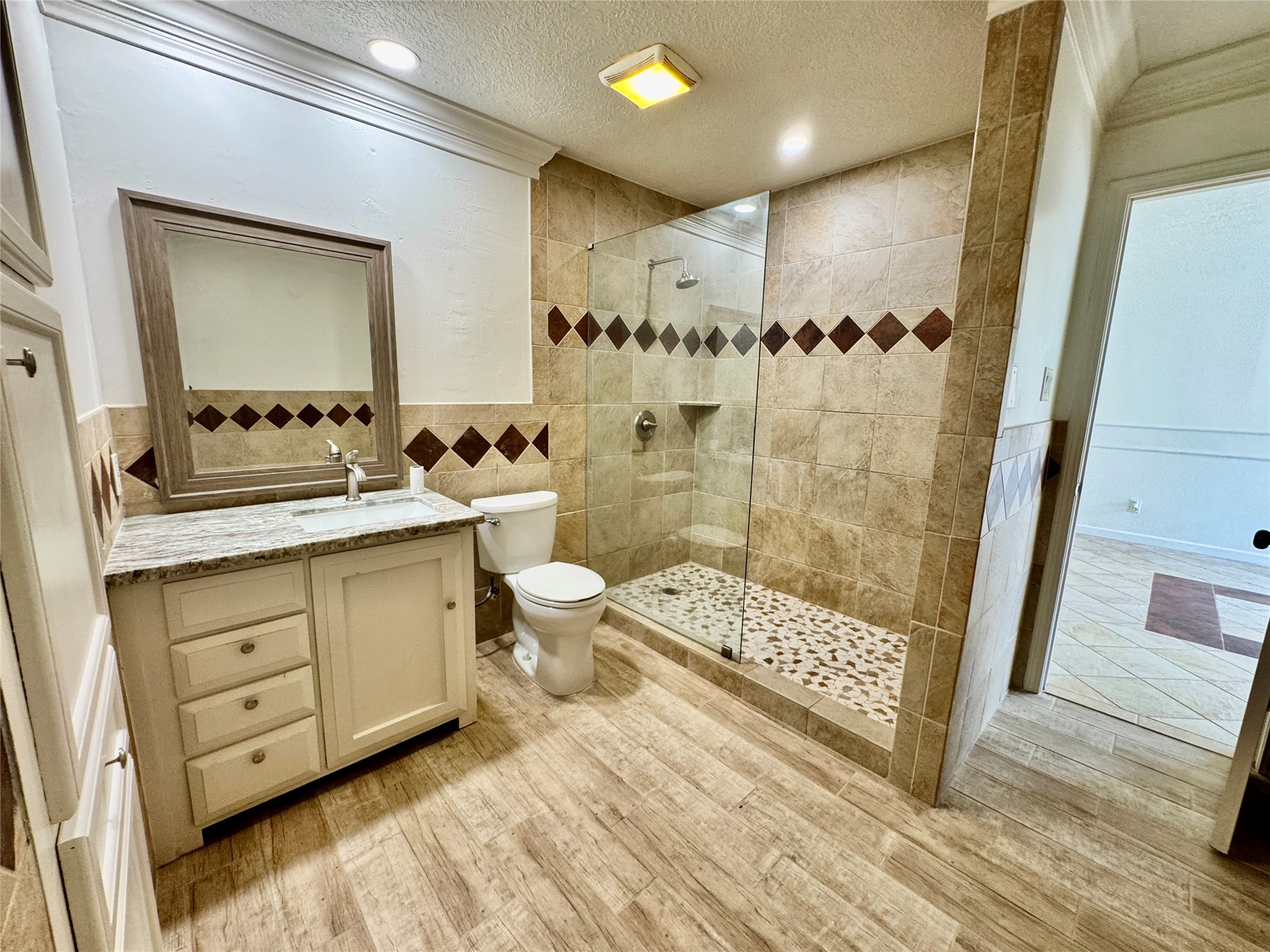 7203 Addicks Clodine Road Houston, TX 77083 - Photo 14 of 21 a bathroom with a double vanity sink toilet mirror and shower