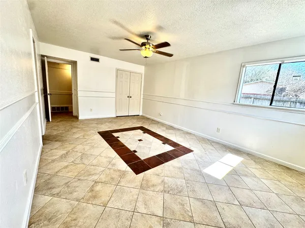 a view of a livingroom with a ceiling fan and window