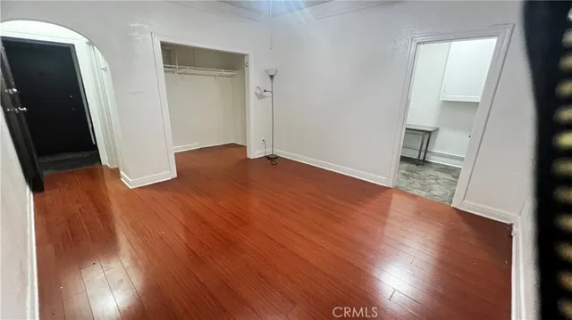 wooden floor in an empty room with a mirror