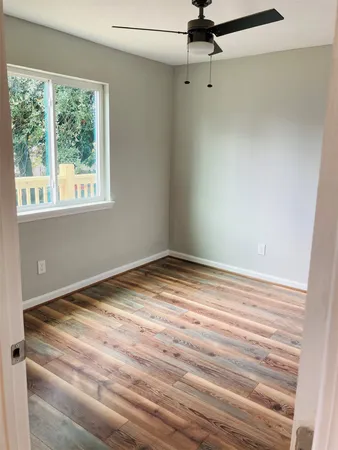 a view of a room with a window and ceiling fan
