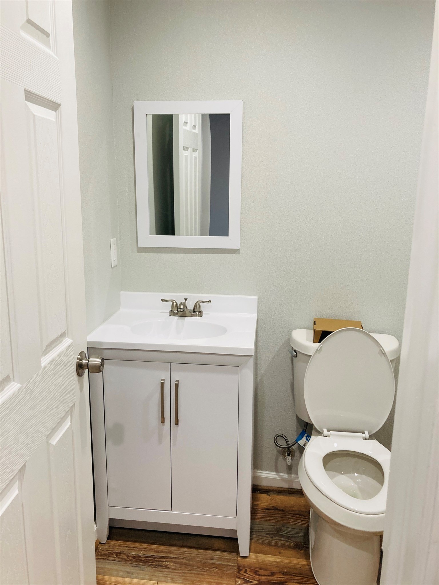807 71st Street Houston, TX 77011 - Photo 6 of 10 a bathroom with a sink a toilet and a mirror