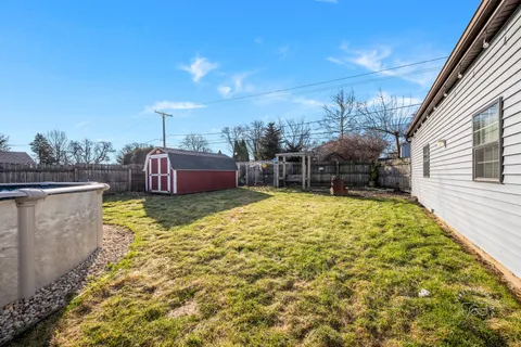 a view of a house with pool and a big yard
