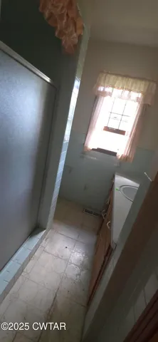 a view of an empty room with windows