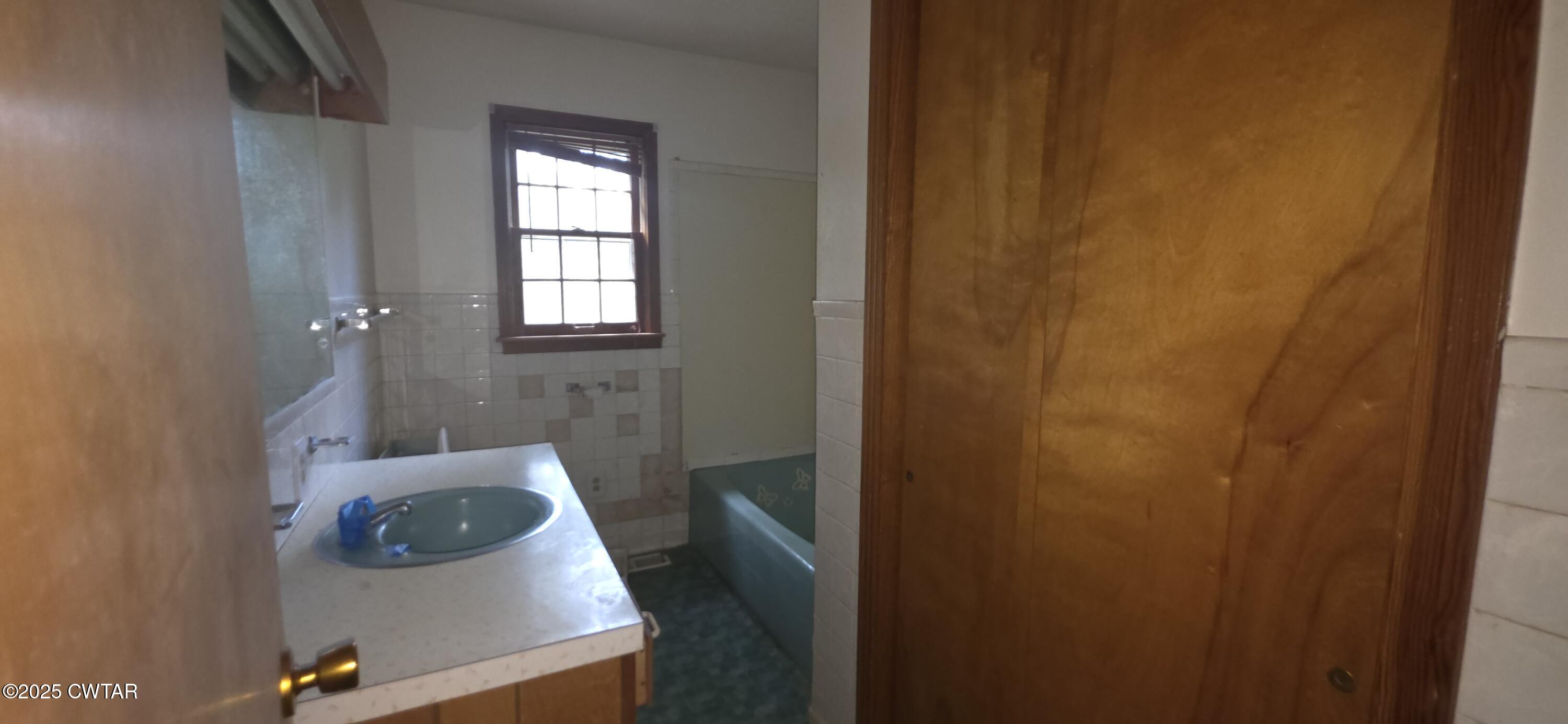 224 Bible Grove Road Lexington, TN 38351 - Photo 13 of 13 a bathroom with a sink and tub