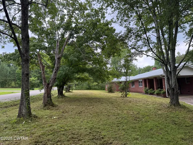 a view of outdoor space with garden and trees