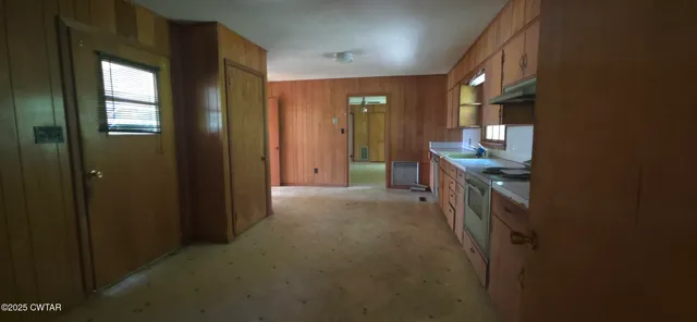 a view of hallway with granite countertop furniture and a sink