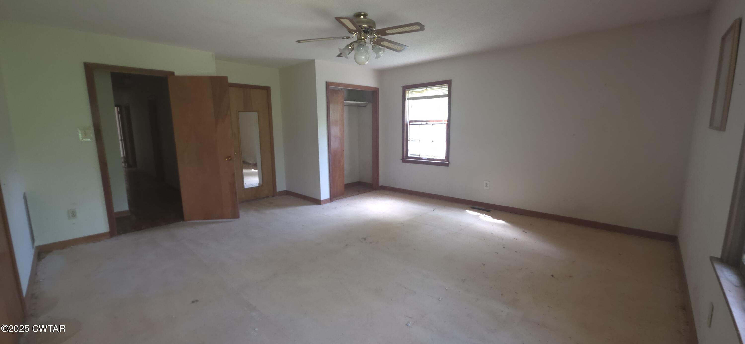 224 Bible Grove Road Lexington, TN 38351 - Photo 9 of 13 an empty room with windows and fan