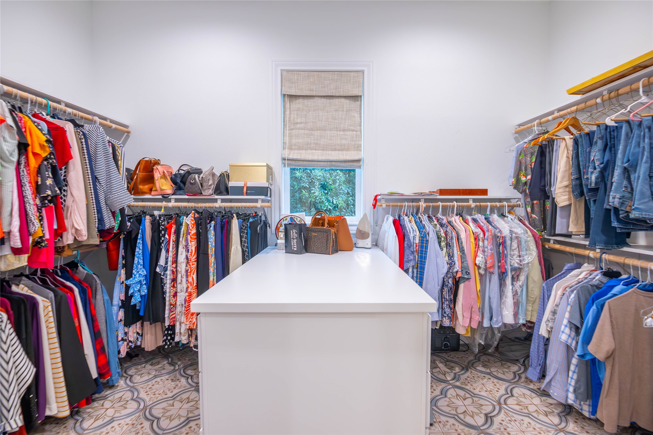 10614 Moonlight Drive Houston, TX 77096 - Photo 19 of 27 a view of walk in closet with clothes and shoes