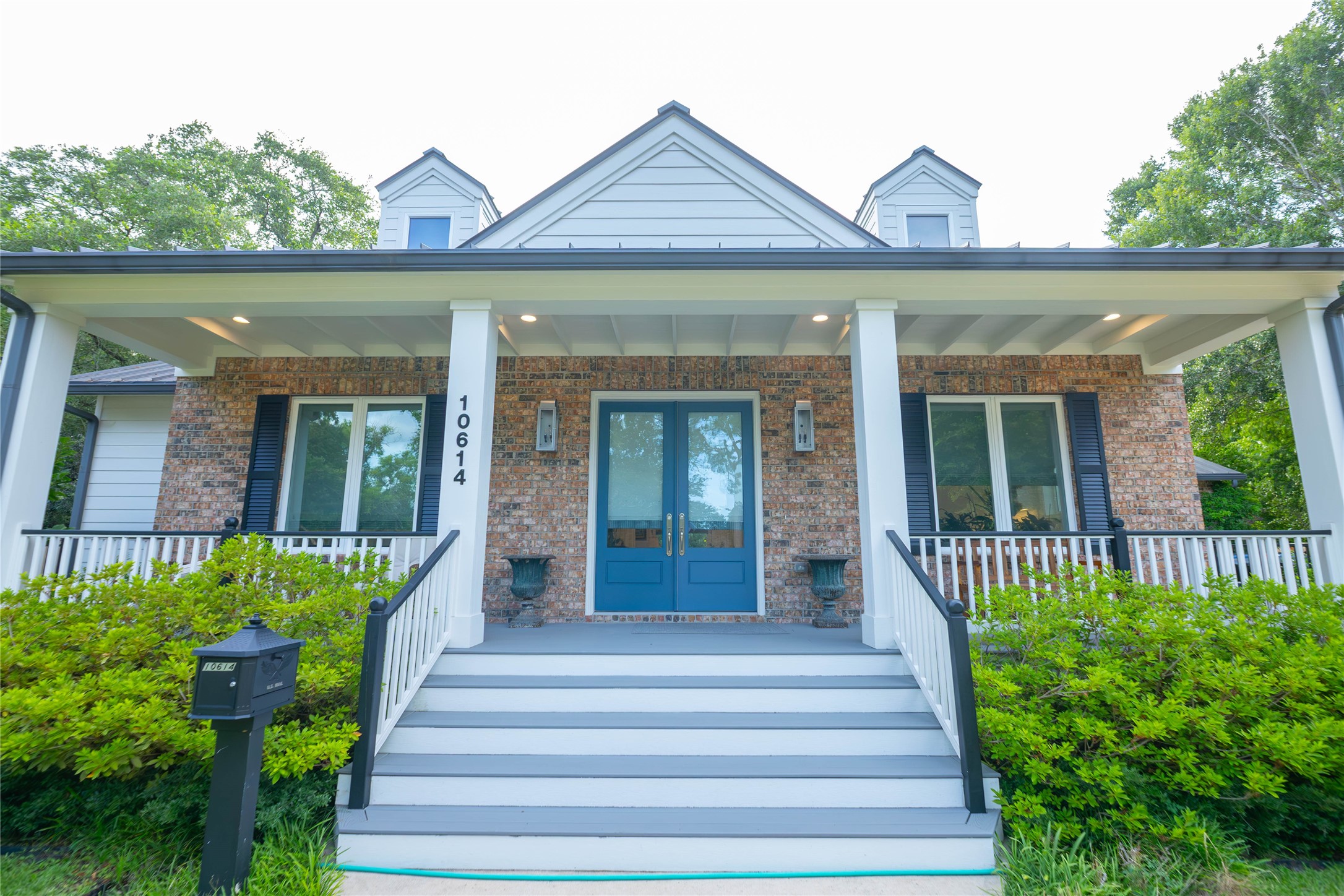 10614 Moonlight Drive Houston, TX 77096 - Photo 3 of 27 a front view of a house with a garden and plants