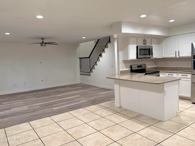a view of kitchen with sink microwave and refrigerator