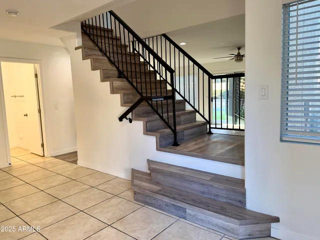 a view of entryway and hall with wooden floor