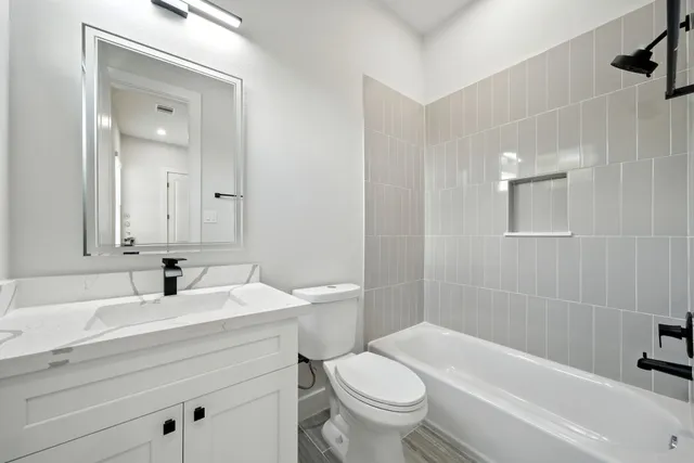 a spacious bathroom with a double vanity sink a mirror and a shower