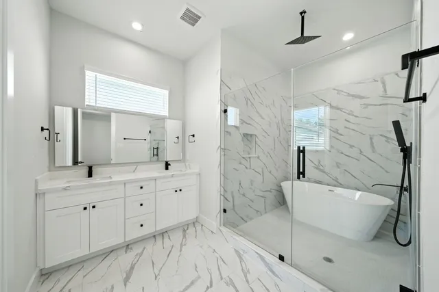 a spacious bathroom with a double vanity sink a mirror and a shower