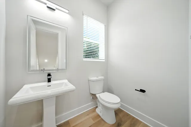 a bathroom with a sink toilet and mirror