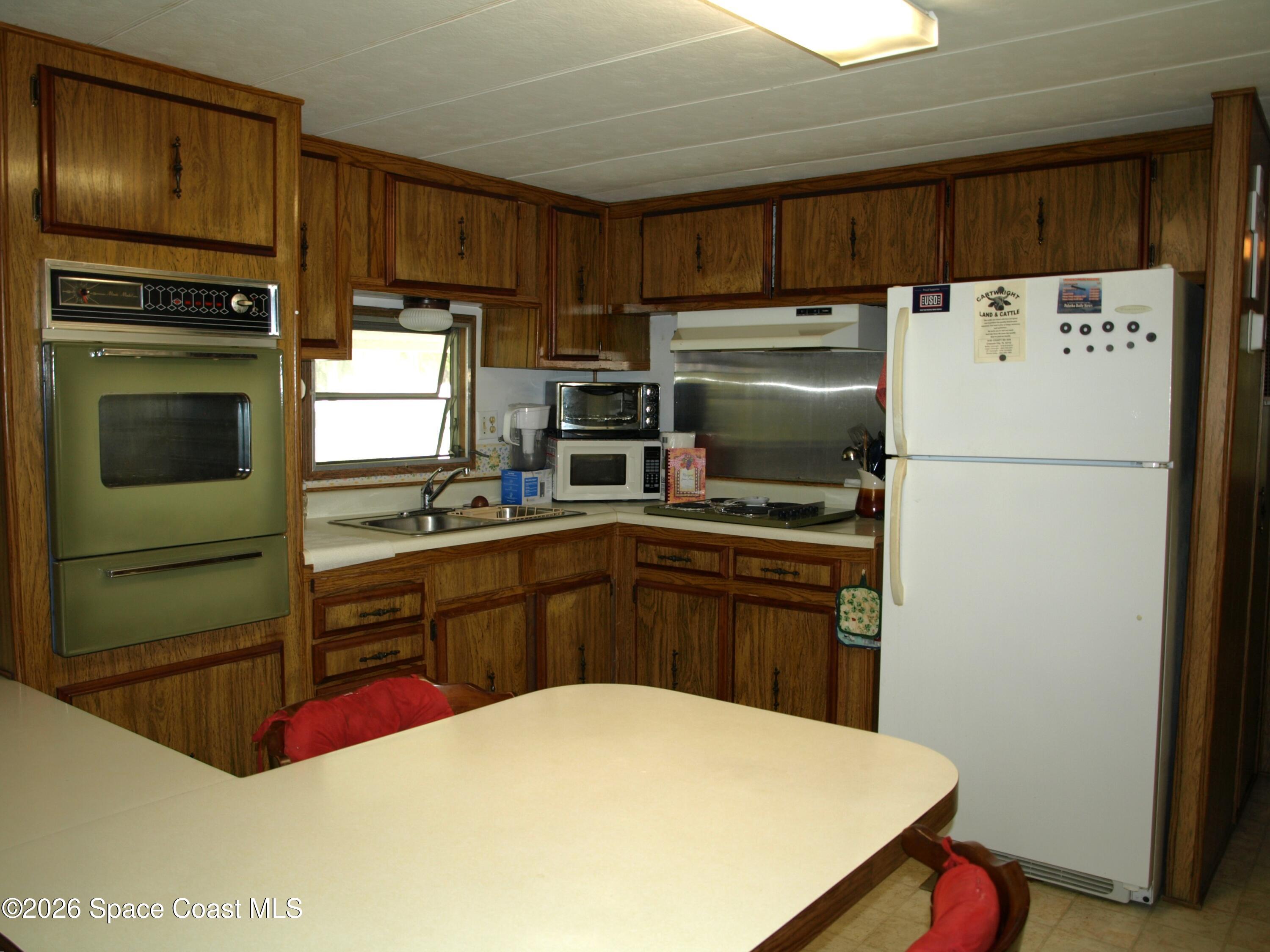 130 Palm Drive Georgetown, FL 32139 - Photo 11 of 23 a kitchen with a refrigerator sink and stove top oven