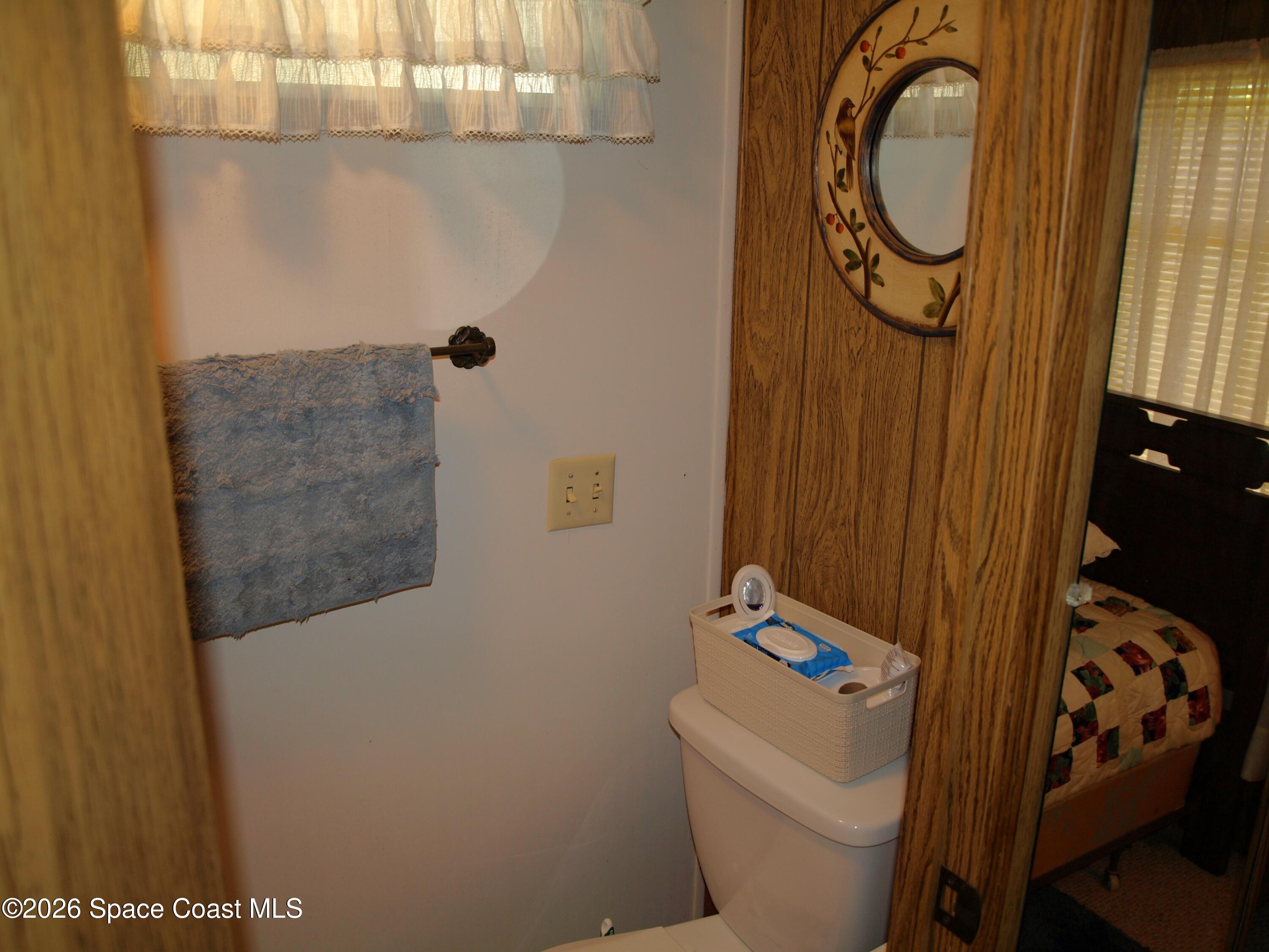 130 Palm Drive Georgetown, FL 32139 - Photo 15 of 23 a bathroom with a toilet and a shower curtain