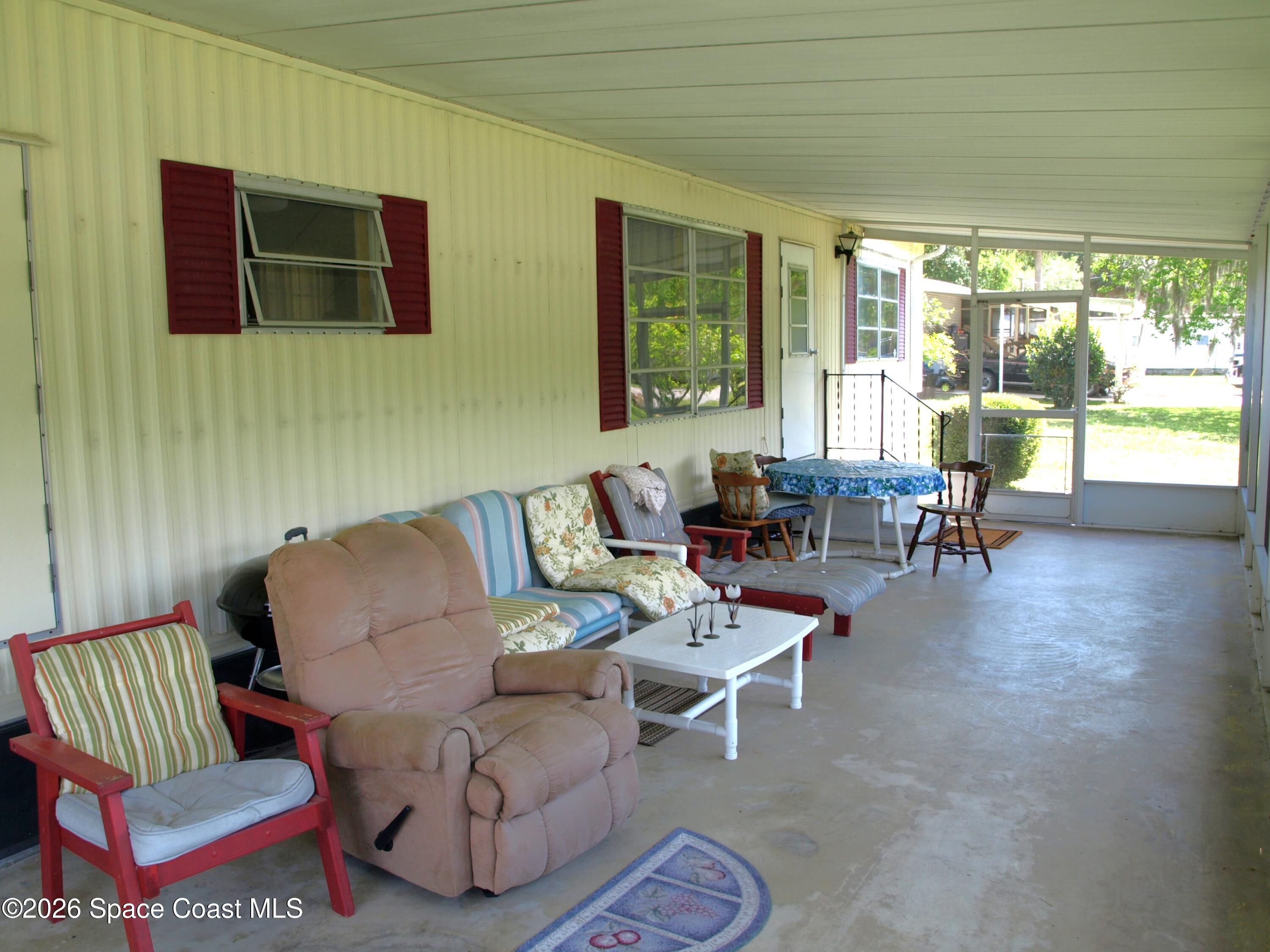 130 Palm Drive Georgetown, FL 32139 - Photo 2 of 23 a living room with furniture and a floor to ceiling window