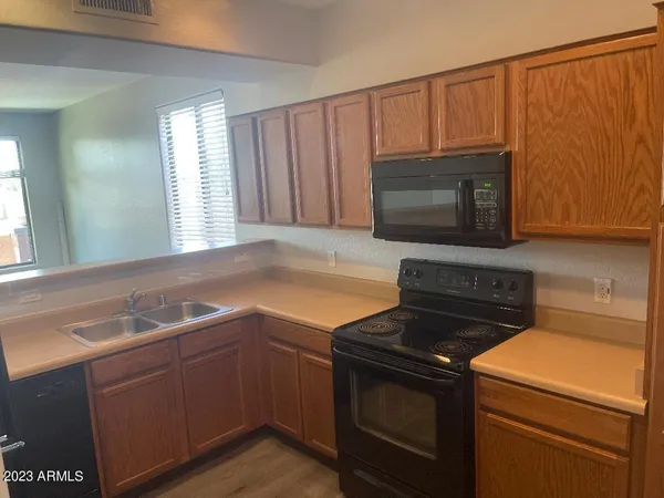 a kitchen with granite countertop a stove and a microwave