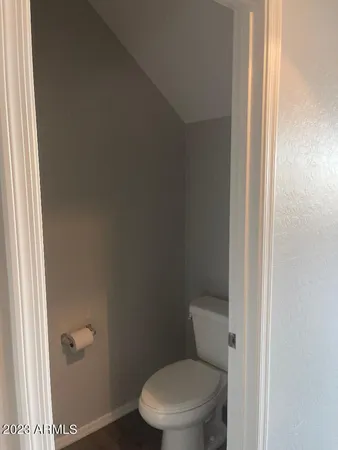 a white toilet sitting next to a shower
