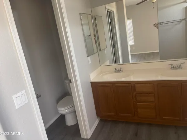 a bathroom with a sink a toilet a mirror and vanity