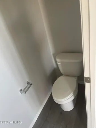 a white toilet sitting next to a white cabinet