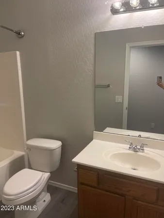 a bathroom with a sink toilet and mirror