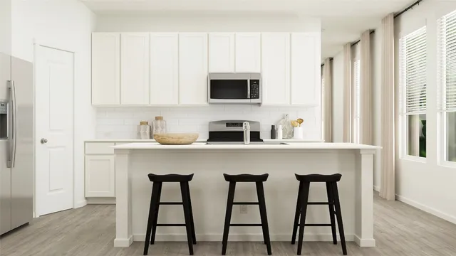 a kitchen with stainless steel appliances granite countertop white cabinets a sink counter space and a window