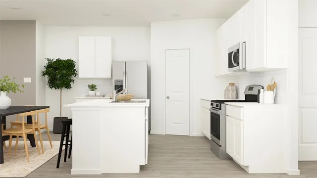 a kitchen with a sink a stove and a refrigerator