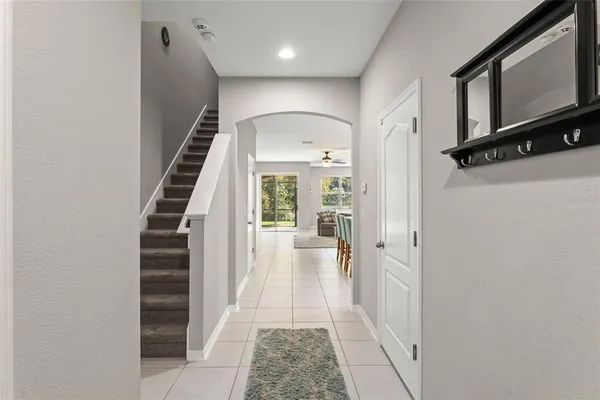 a view of a hallway with wooden floor and staircase