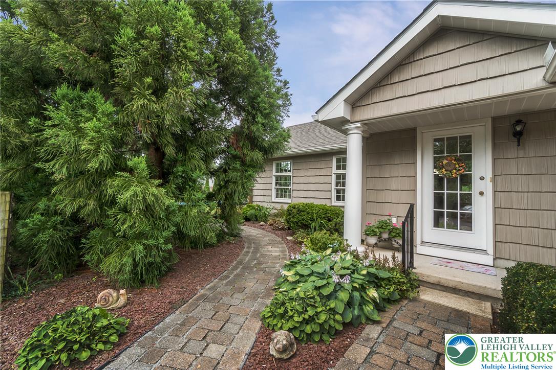 525 Wedgewood Road Bethlehem, PA 18017 - Photo 57 of 61 A charming paved pathway leads to a welcoming side entrance with lush landscaping.