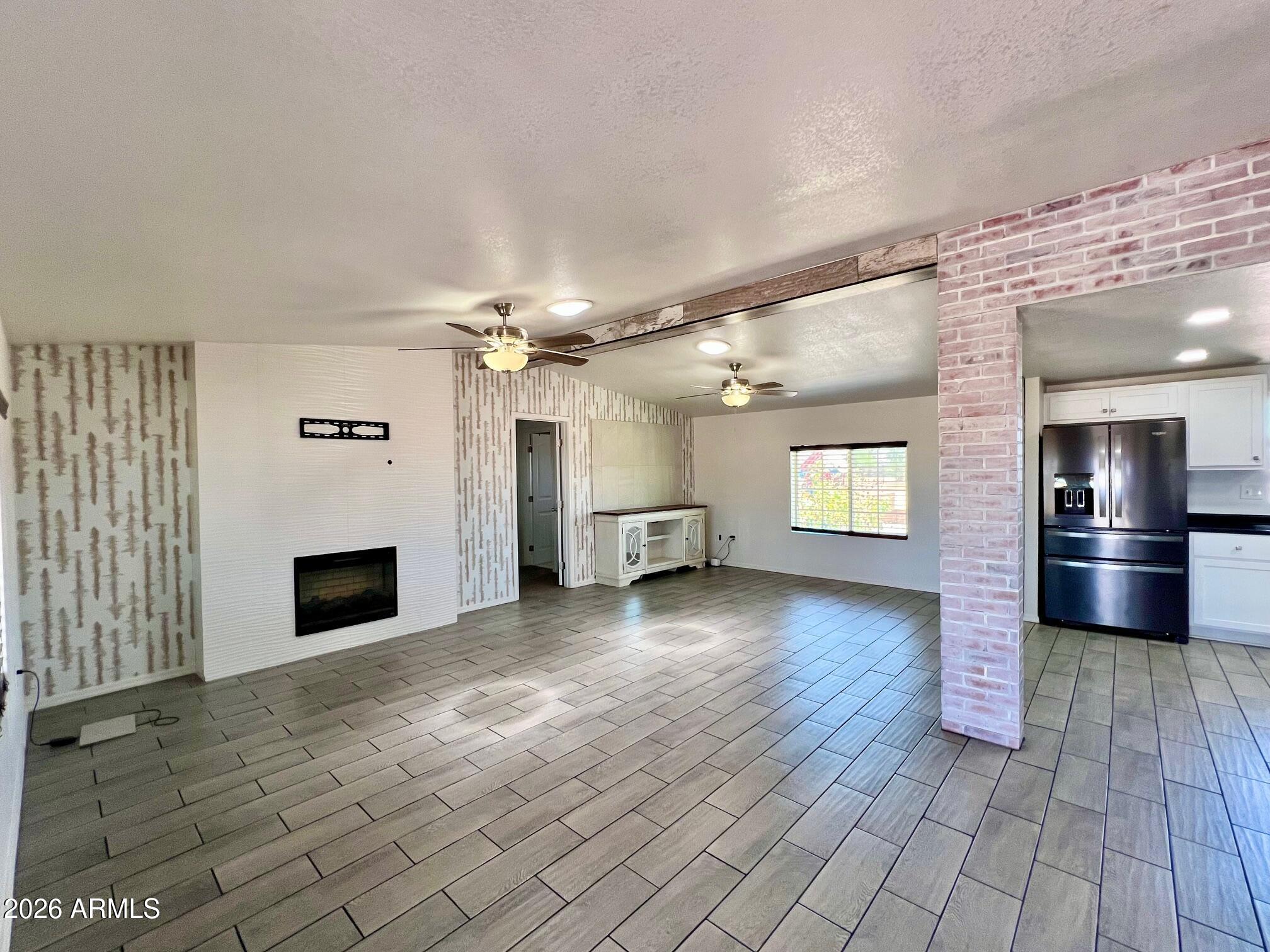 12035 East Tennyson Road Florence, AZ 85132 - Photo 15 of 42 an empty room with windows and fireplace